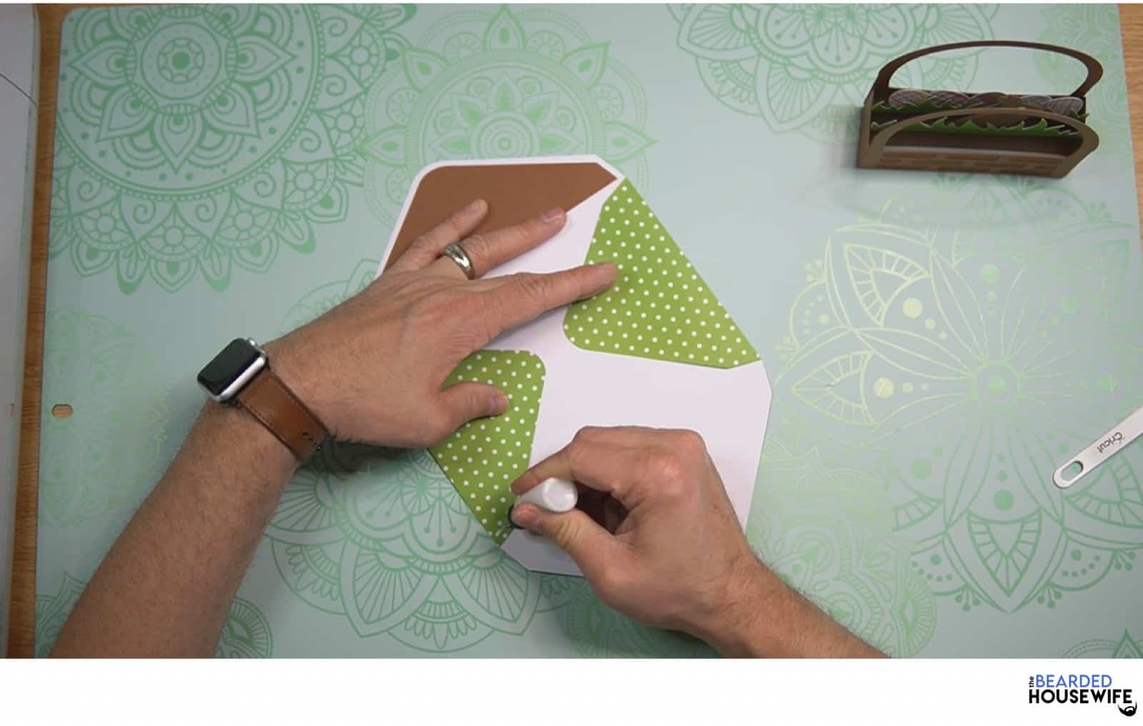 add glue along the side flaps of the envelope