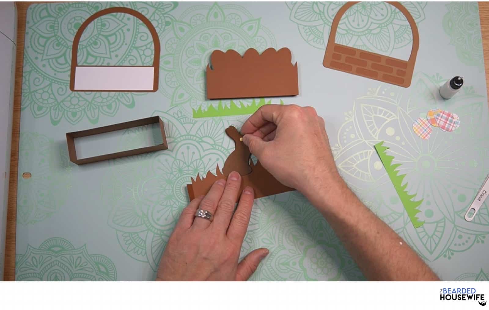 layer the chocolate bunny and eye then adhere to the inside piece