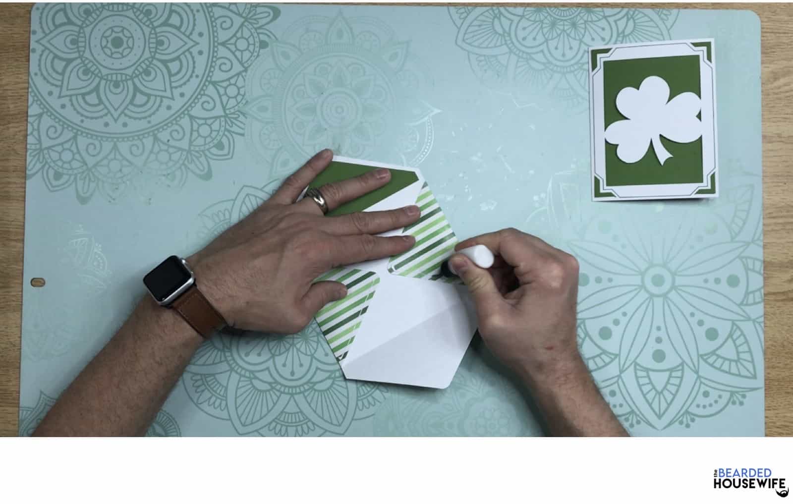 add glue along the side flaps of the envelope